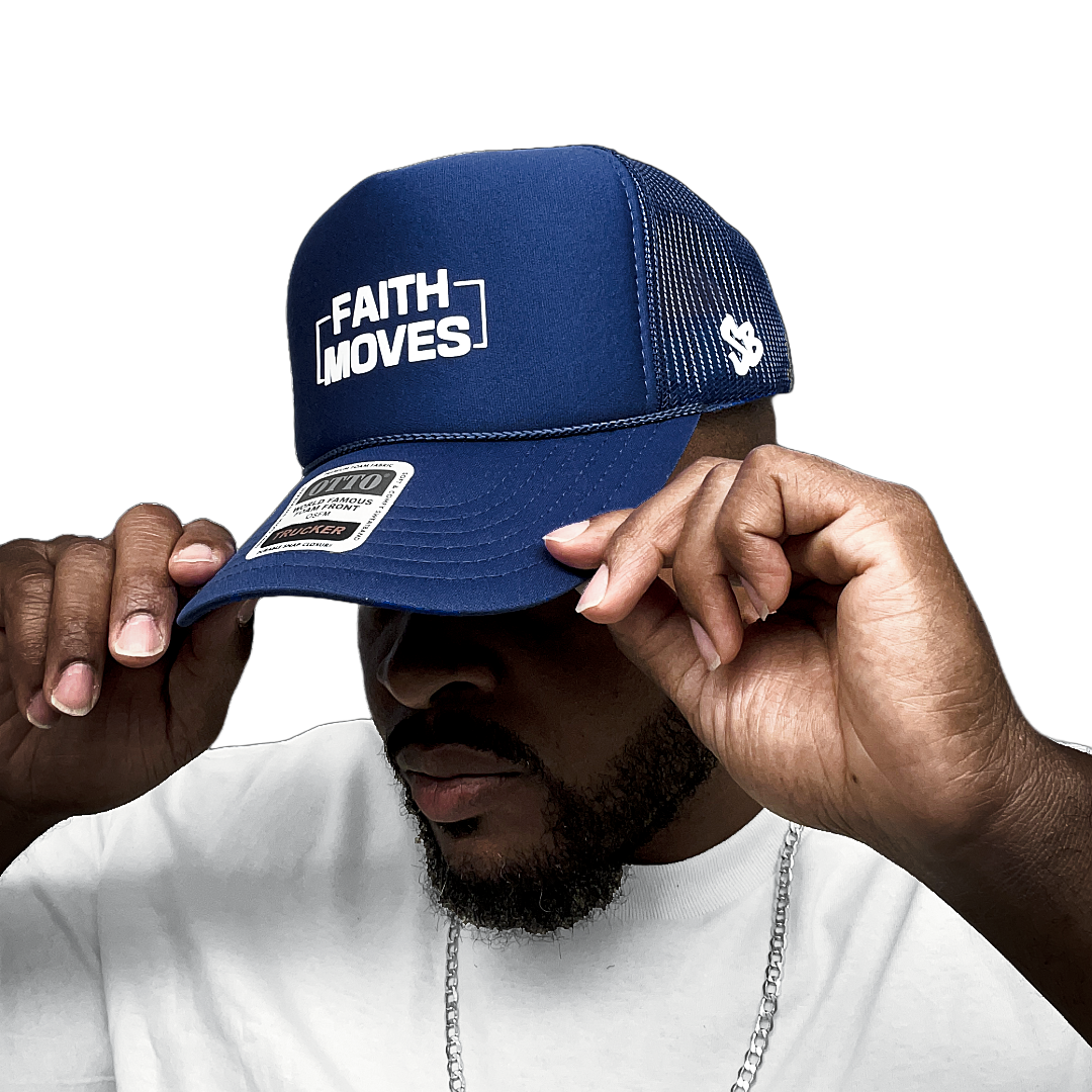 Navy blue Faith Moves trucker hat with white embroidered logo, worn by model adjusting the brim – mesh back and SB logo visible

